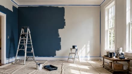 Interior repaint in progress with ladder and navy accent wall